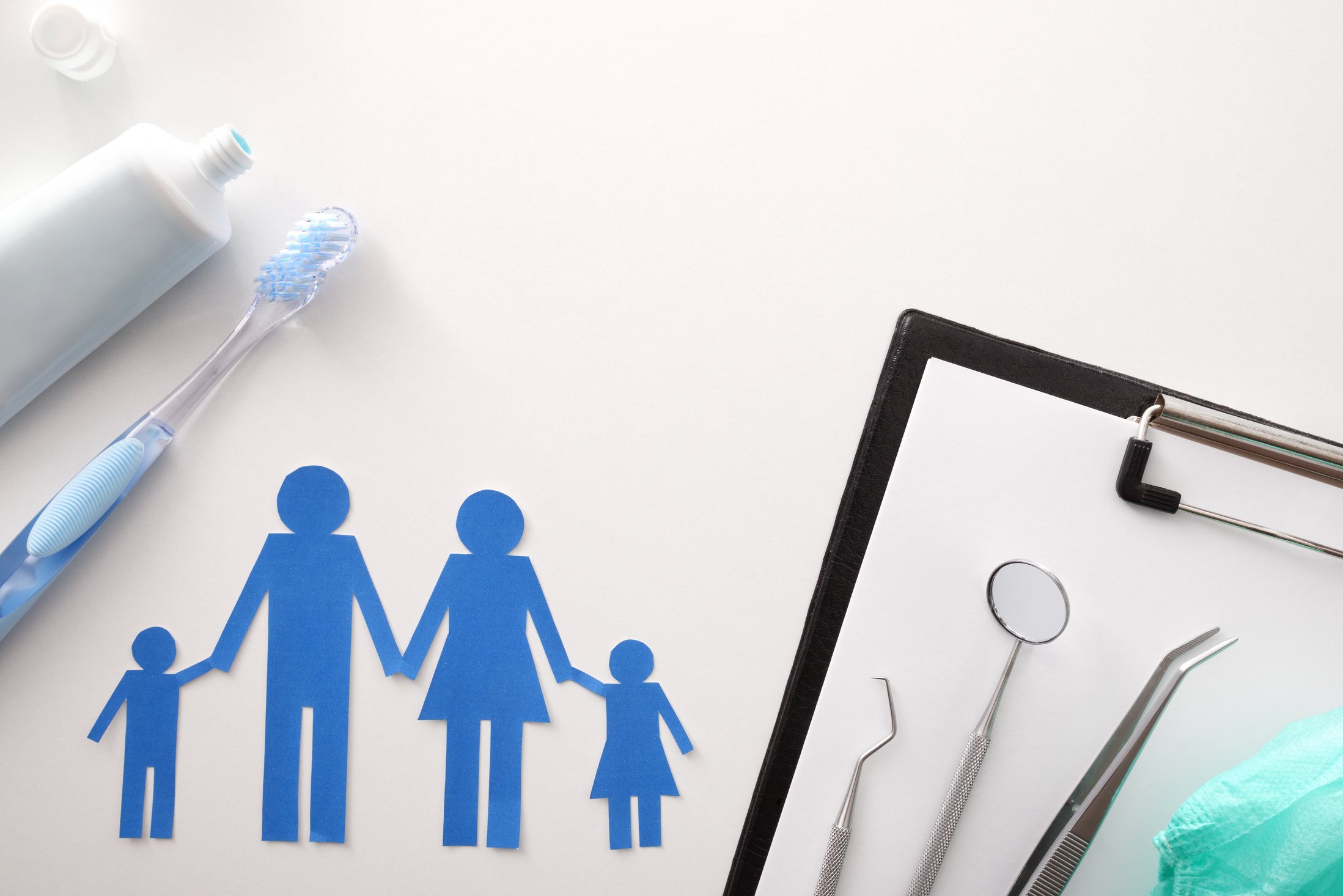 Concept of family dental insurance on white table top